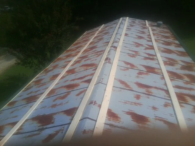Rusted metal roof panels with new wood purlins before replacement — Storm Damage Roof Repair in Jbsa Ft Sam Houston by Roofing Brothers