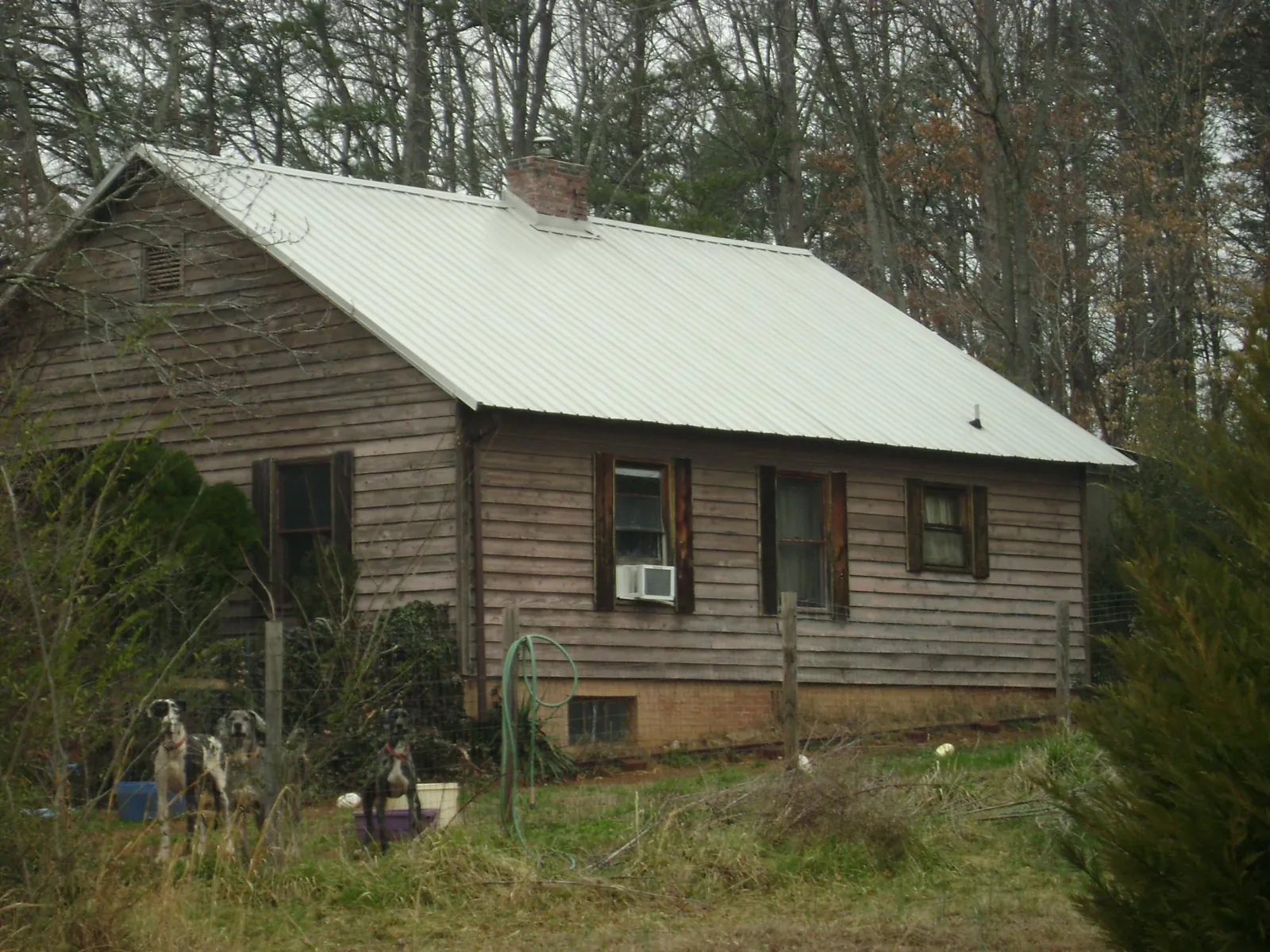 White metal roof on an old wood sided farmhouse, from a Metal Roof Installation job in Jbsa Ft Sam Houston